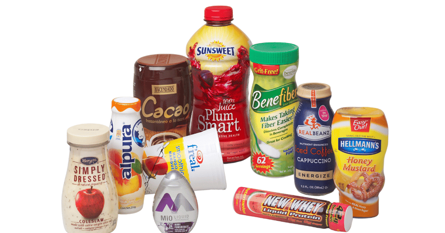 Various containers of all shapes and sizes shrink sleeved with precision applied labels including salad dressing, honey mustard, juice, coffee, liquid protein, and more